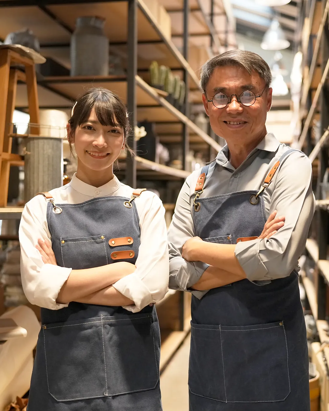 Two shop staff standing in their store